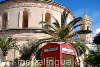 Una cabina telefonica rossa davanti alla chiesa di Mosta